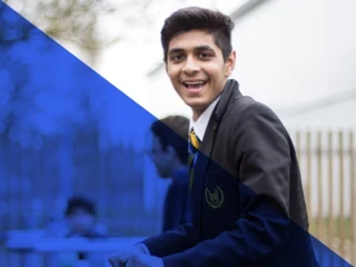 Teen boy in school uniform looks at camera