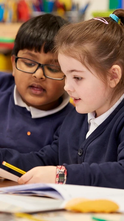 Two primary school pupils in maths class