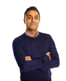 Man smiles with his arms crossed