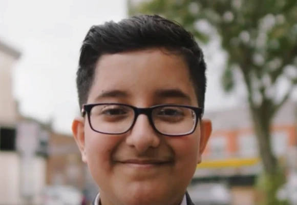 Rayyan, pupil wearing glasses smiling at camera