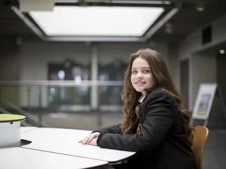 Secondary pupil seated at a table, looking to camera.