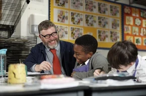 Teacher and student laughing and smiling together