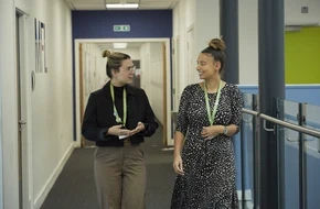 Image of two teachers from Castle Mead walking and talking